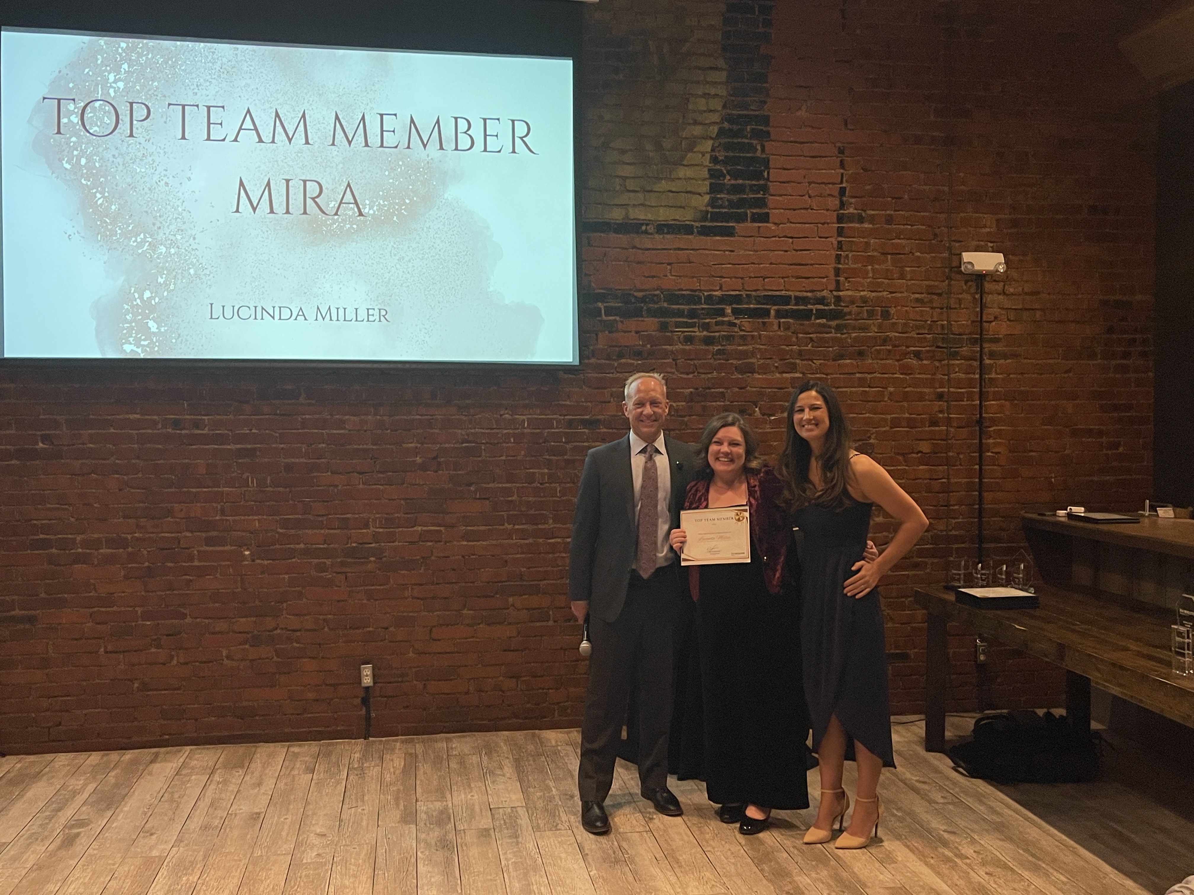 Lucinda Miller receiving a Top Team Member award